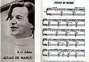 Pintura a óleo retratando o compositor Tom Jobim sentado ao piano, com partituras e instrumentos musicais ao redor.